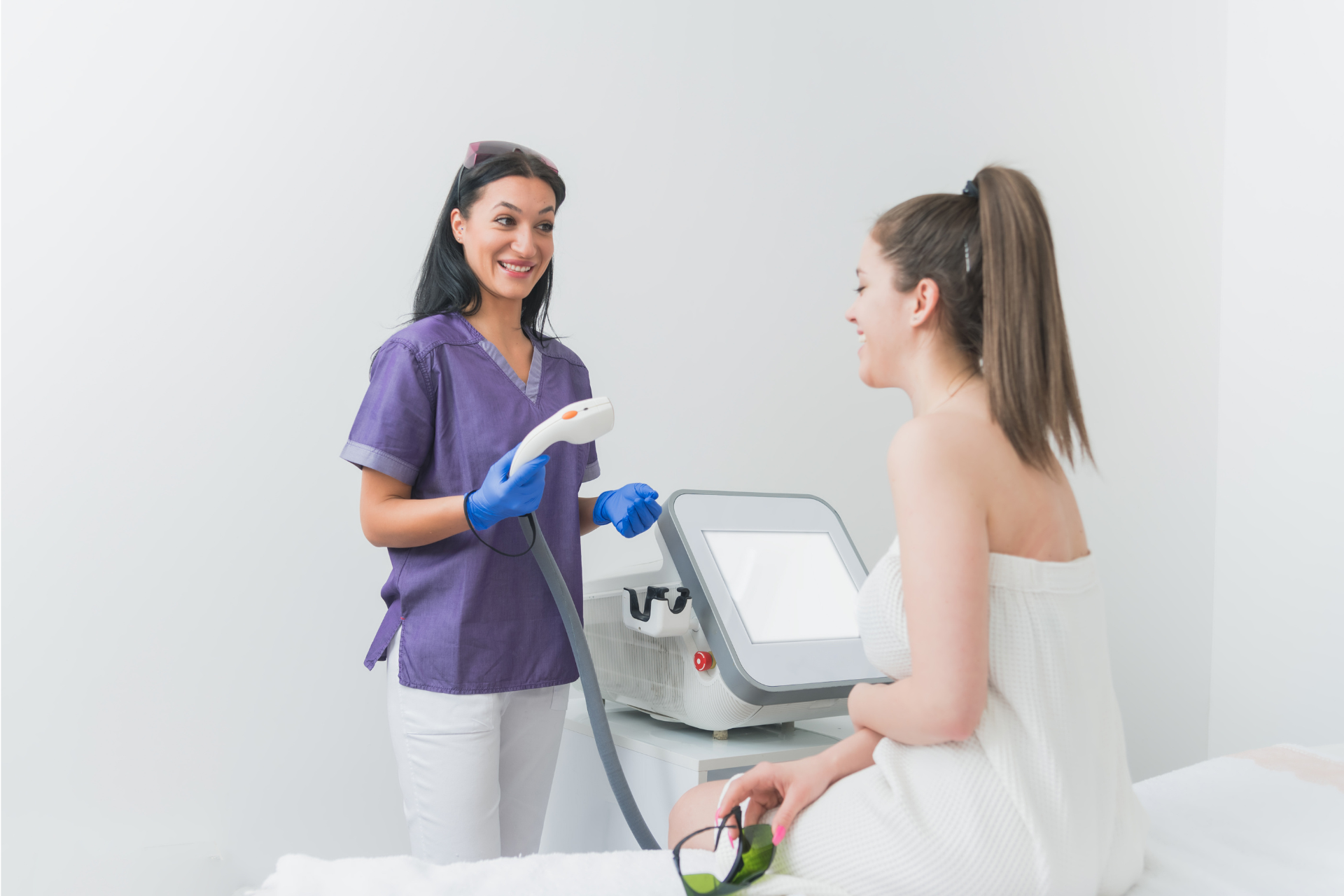  a woman speaking to a laser technician about the procedure