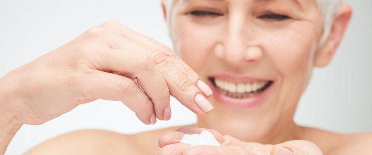 Women applying skin care product from APT Aesthetics