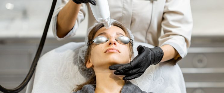 A woman getting halo treatment on her forehead