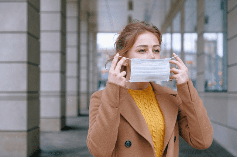 Woman putting on a mask