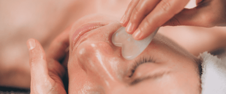 Close up of a woman having a Gua Sha facial