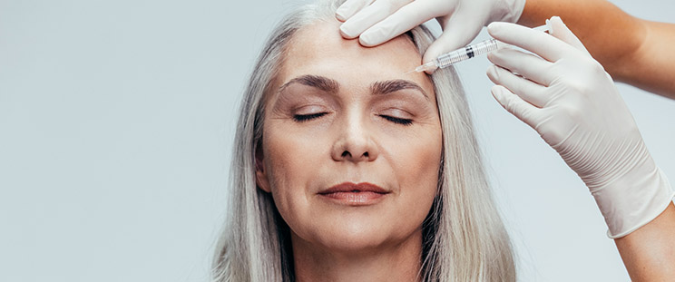 A woman receiving Botox treatment on her forehead