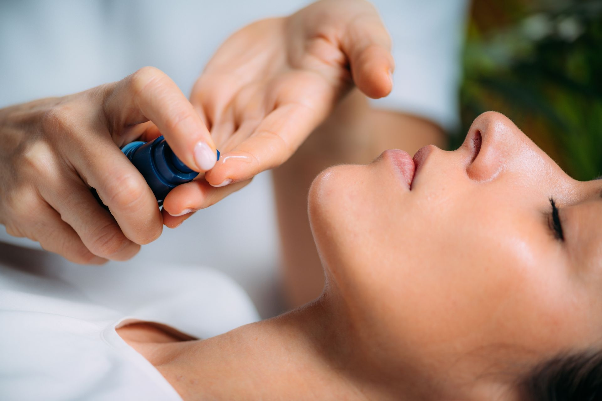 A skincare expert applying retinol to a client’s face