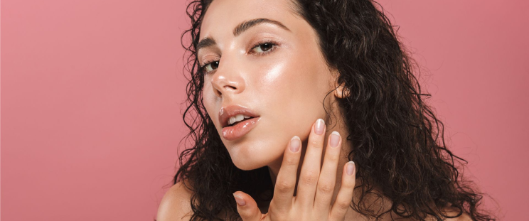 A woman showing off her skin’s dewy glow.