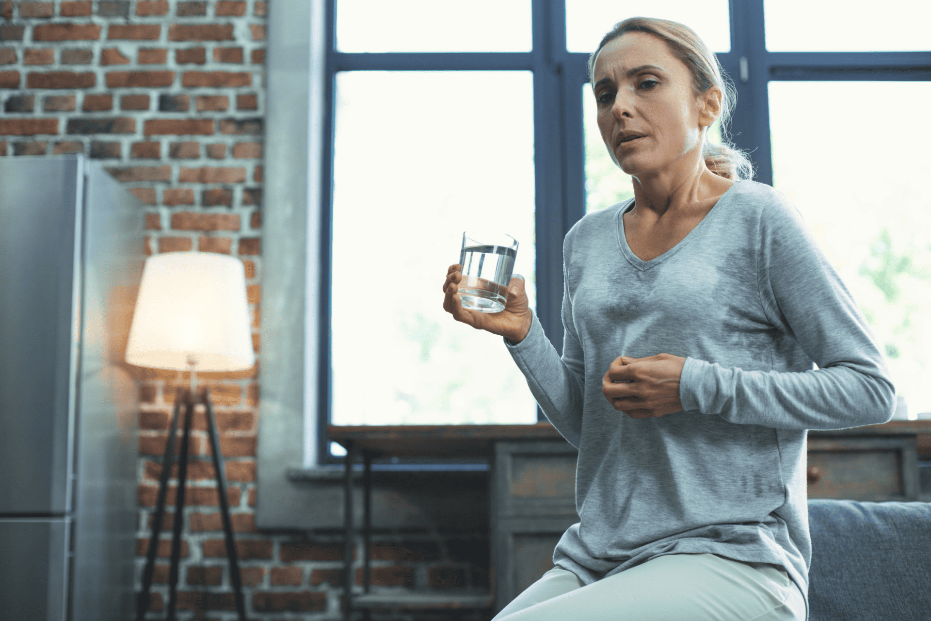  a middle-aged woman experiencing symptoms of menopause 