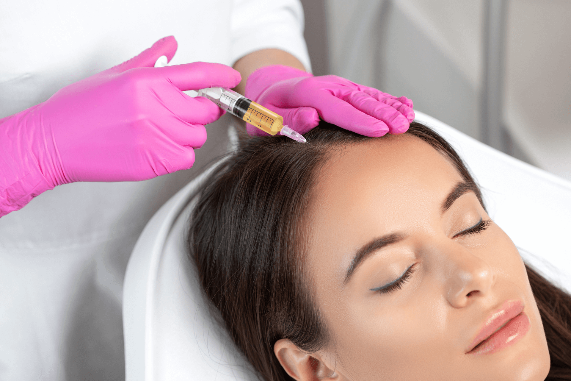 a woman receives hair loss treatment 