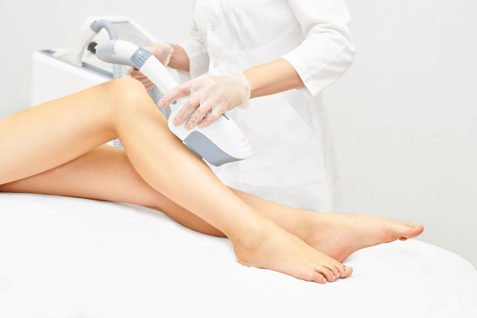 A patient receiving IPL treatment on their legs 