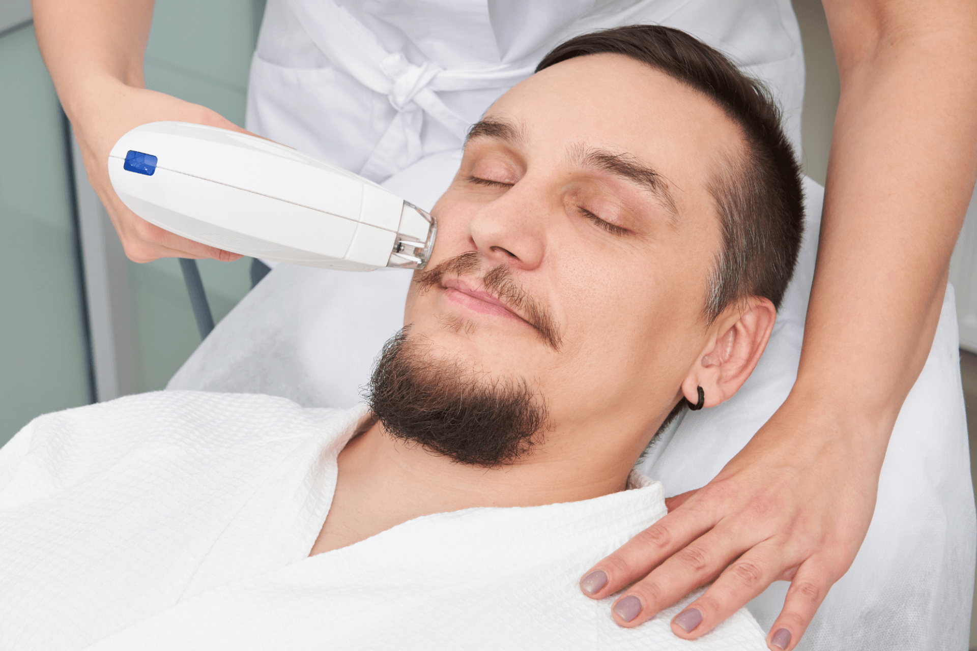 A medical aesthetician uses BBL laser on the face of an adult man 