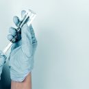 A medical professional draws a syringe